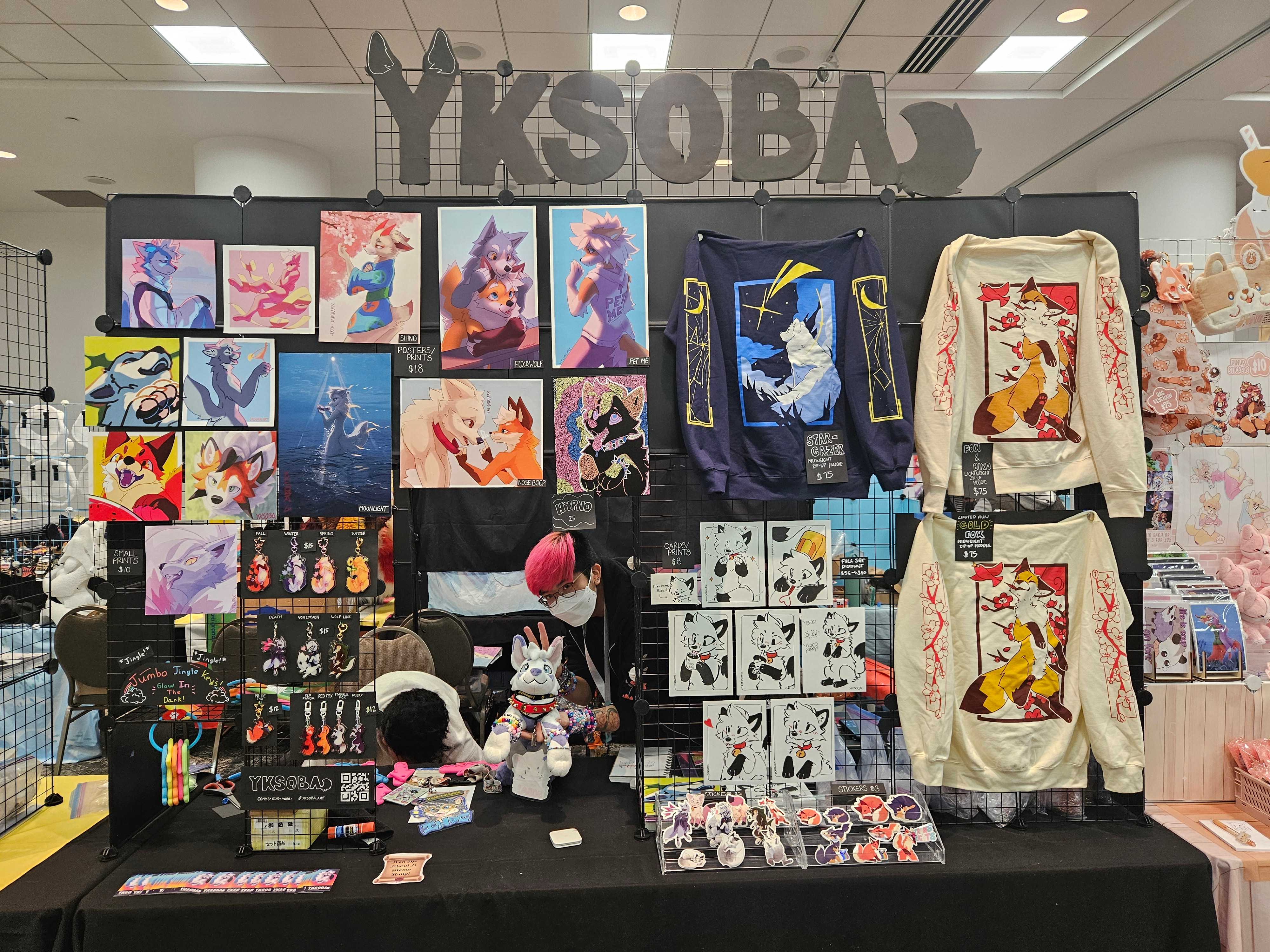 Rye (my partner) behind the table at FurSqared '26