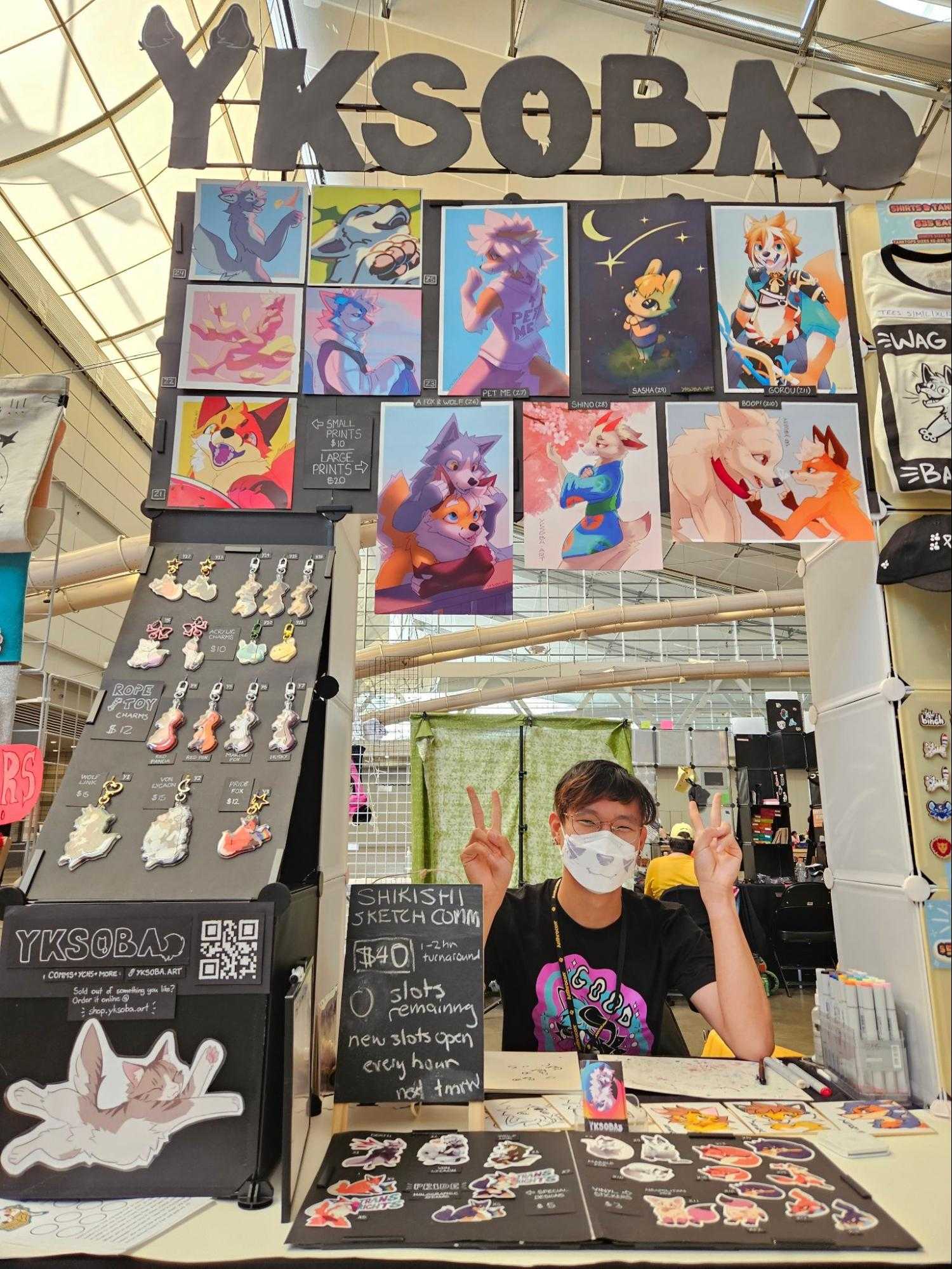 Soba (me) behind the table at Anthrocon '24