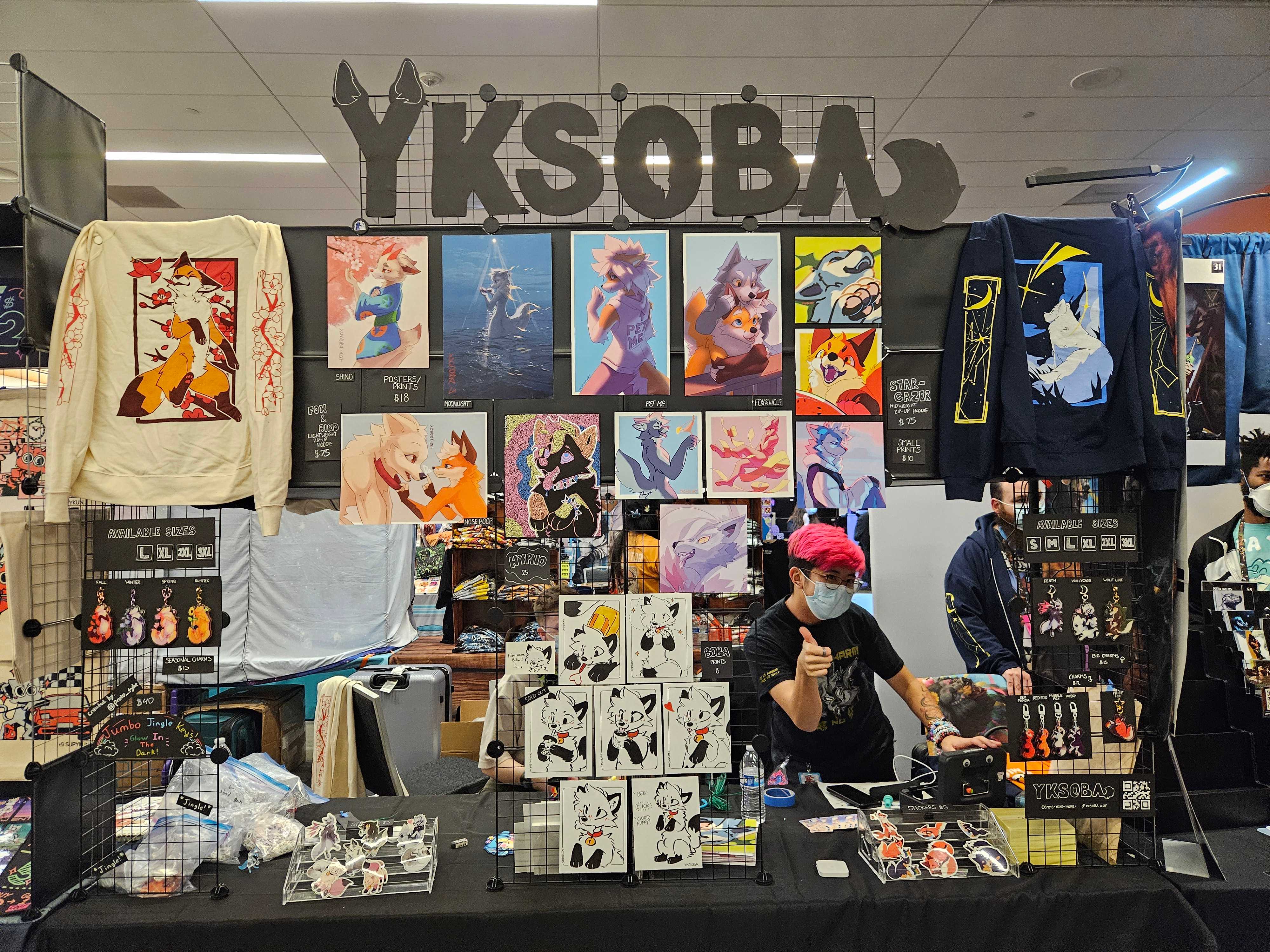 Rye (my partner) behind the table at FurtherConfusion '26