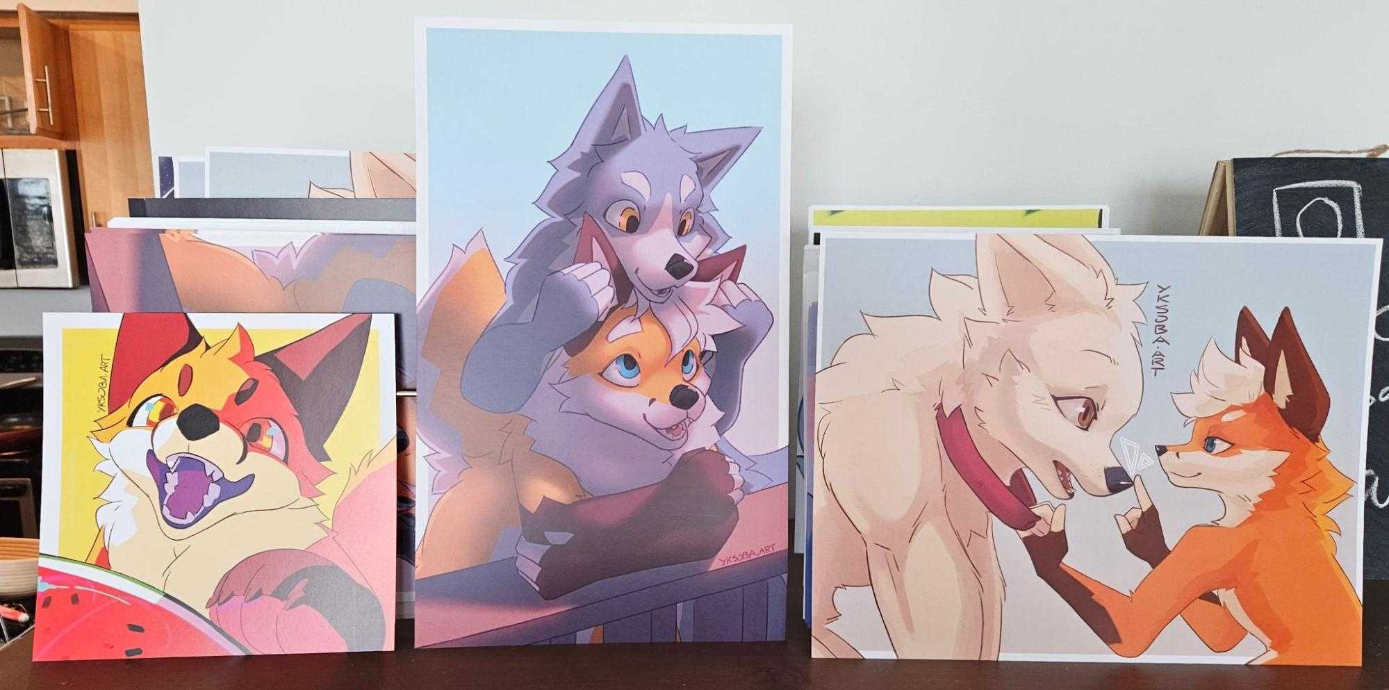 Three prints (in order from left to right): fox about to bite into a watermelon; a wolf playing with a foxes ears; a fox touching the nose of another dog