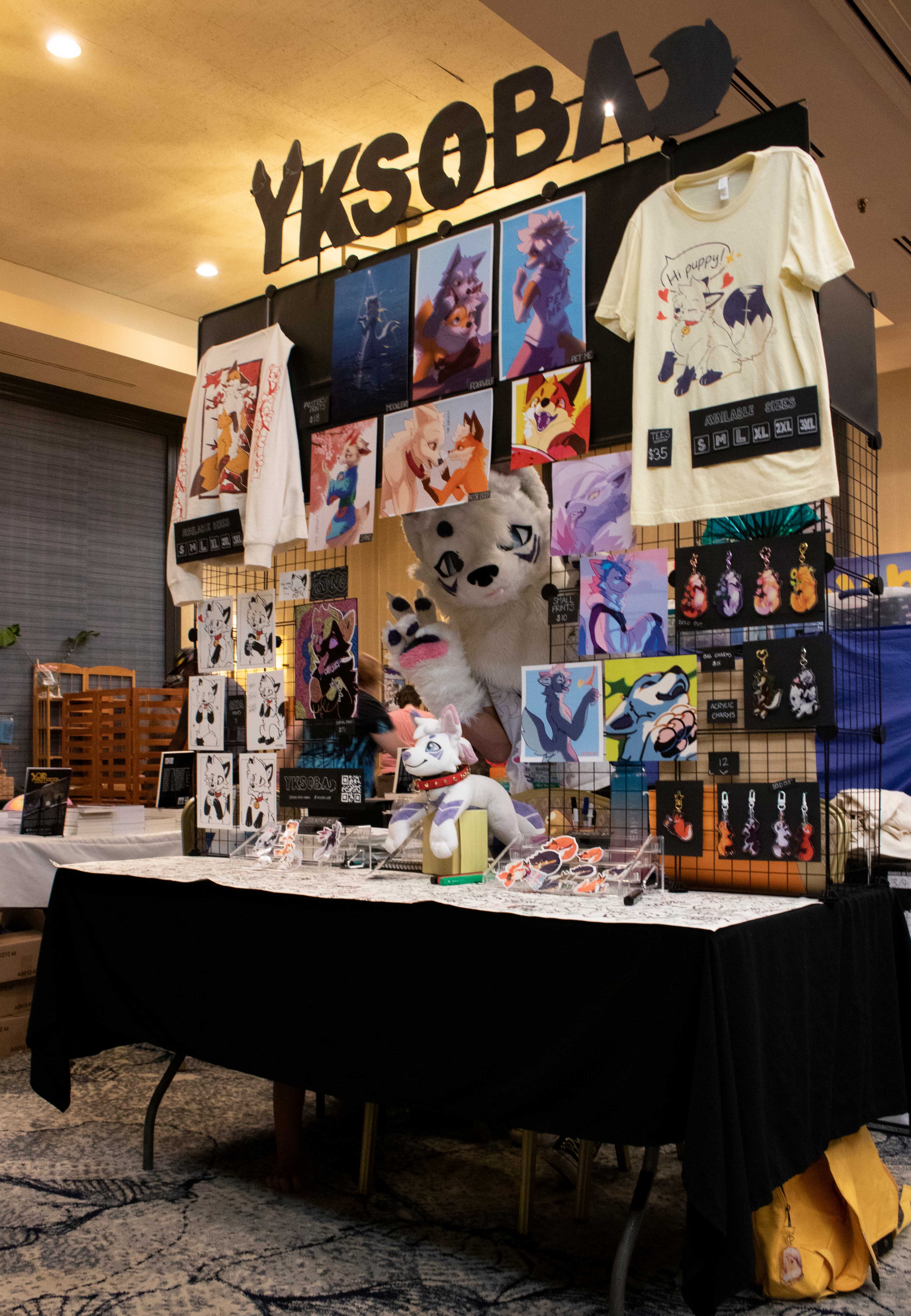 Soba (me) in fursuit behind the table at IndyFurCon '25