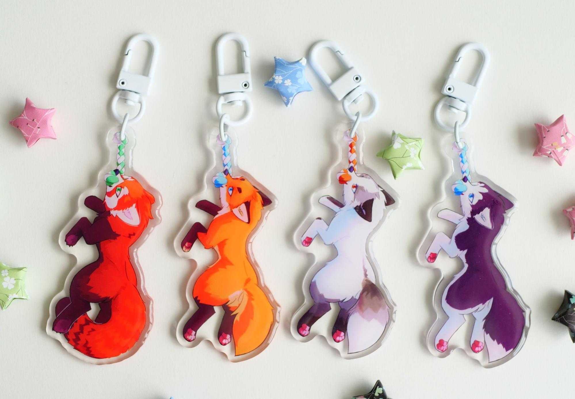 Four acrylic charms of various canids (and a red fox) dangling from rope toys