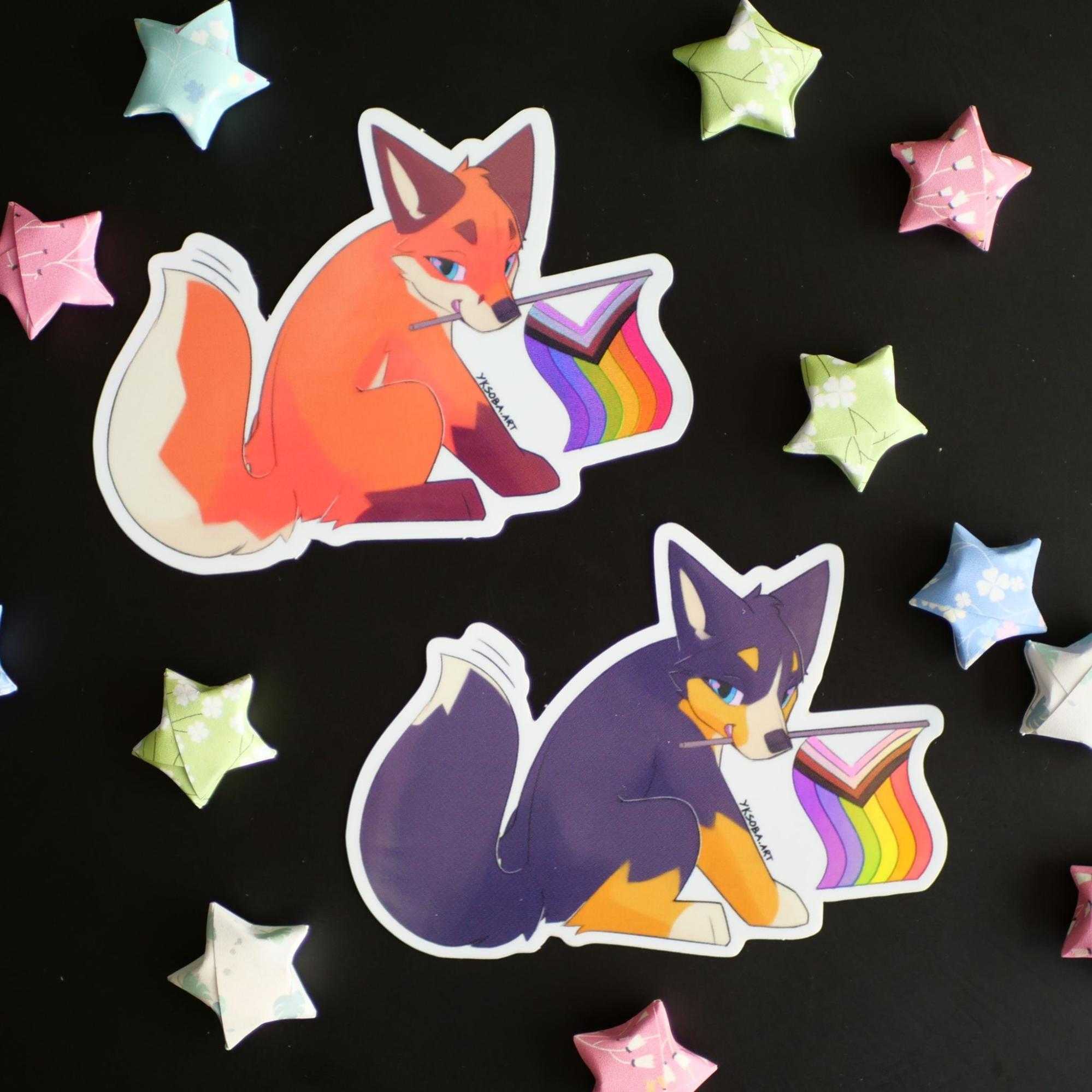 Two stickers of canids sitting and holding pride flags in their mouths